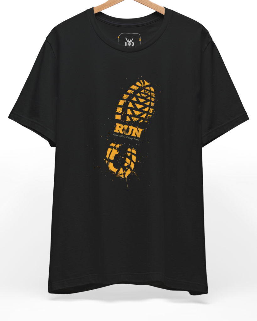 A high-end display of the official Holydeer Trail Running Tee showcasing unique Boutique Activewear design lines. The central Runner Gift T-Shirt graphic features a miniature Wilderness Track T layout centering a detailed Muddy Footprint Top design with a solid gold print look and textured splatters on a black shirt canvas.