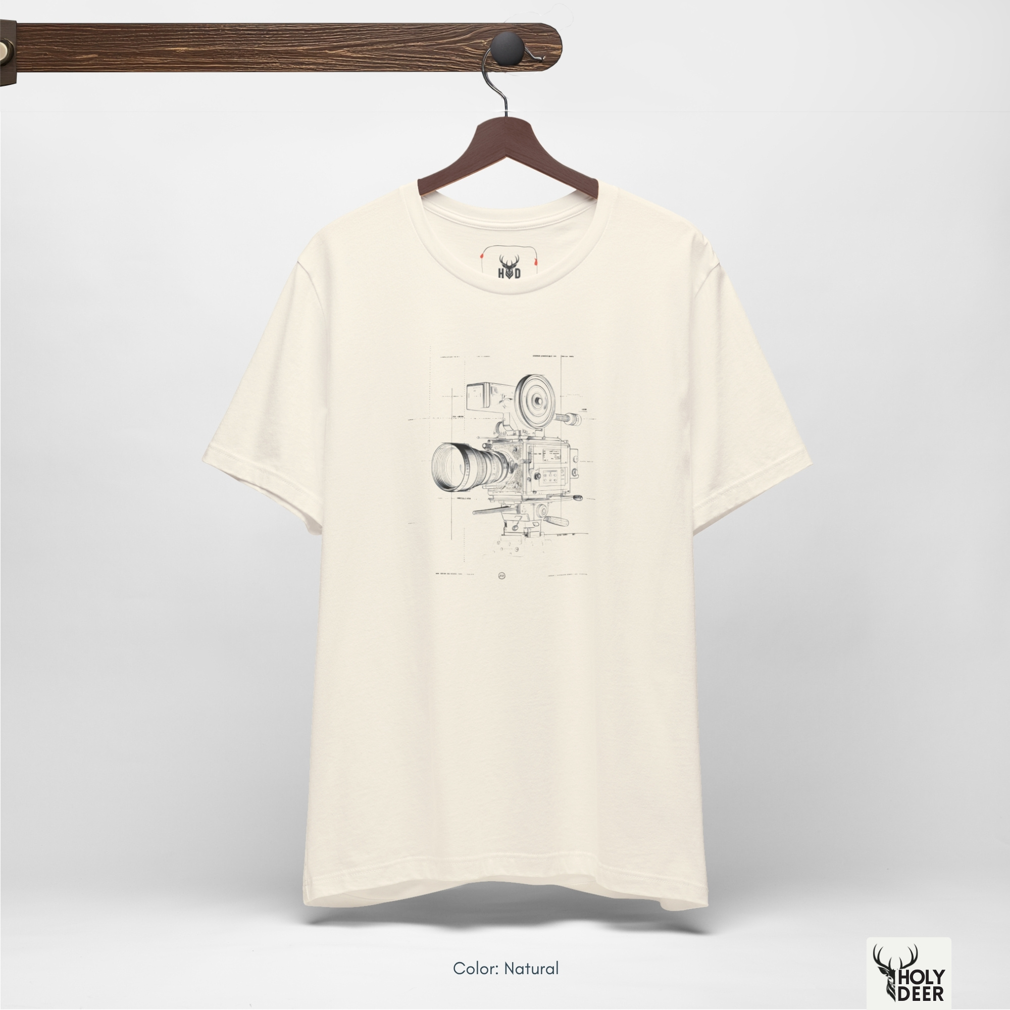A commercial catalog layout tracking the Holydeer Clothing Film Director Tee hanging cleanly from a custom timber stand. The product framework documents accurate filmmaker gift shirt material behavior, soft chest wrinkles, and balanced square casual fit parameters for high-end boutique distribution.