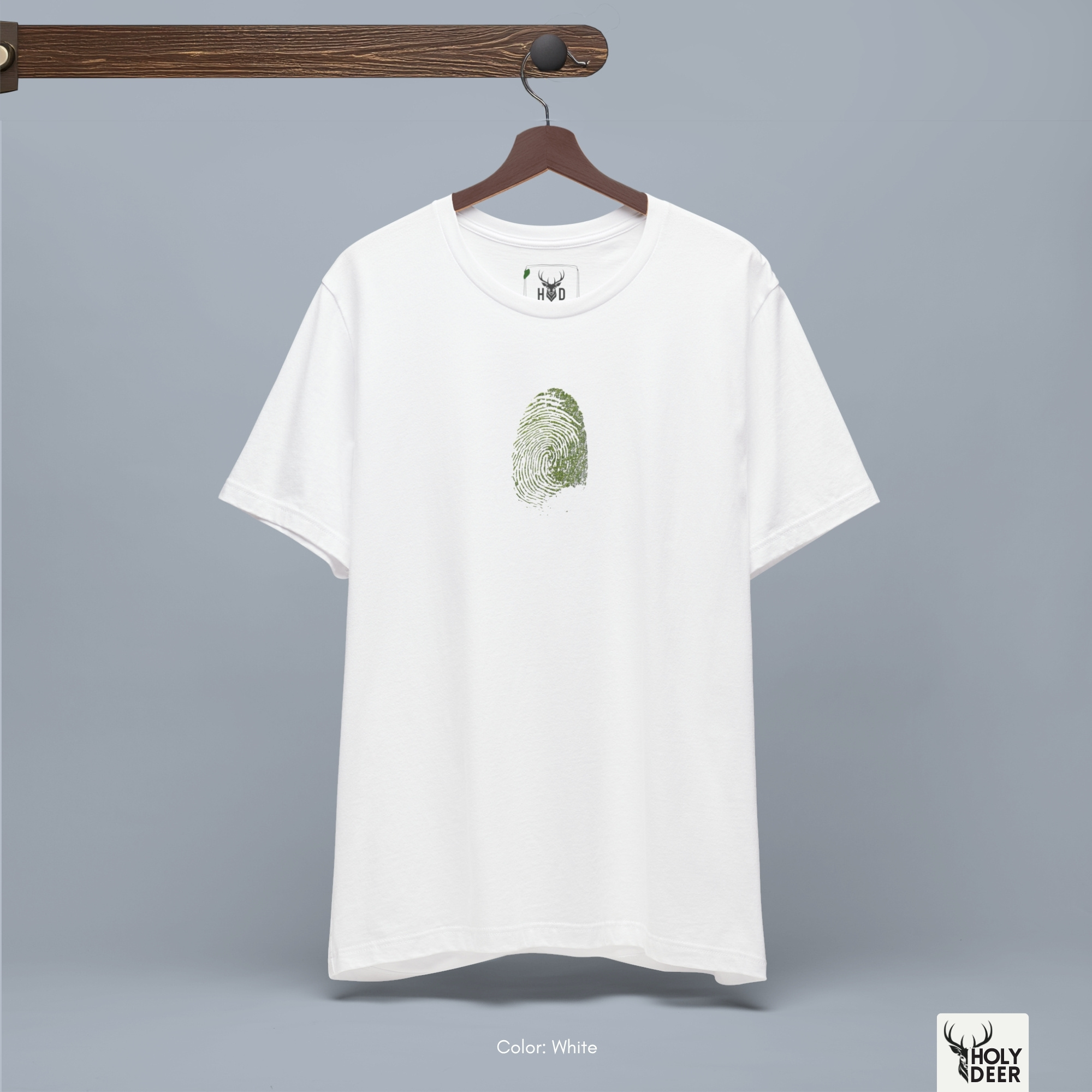 A close showroom catalog viewpoint of the Holydeer Apparel Green Identity Tee showing the specialized Boutique Activewear printing finish. The framework tracks the tight screen registration of this Sustainability Shirt and Organic Vibe Apparel selection to monitor deep design style rendering, material texturing behaviors, and light reflection.
