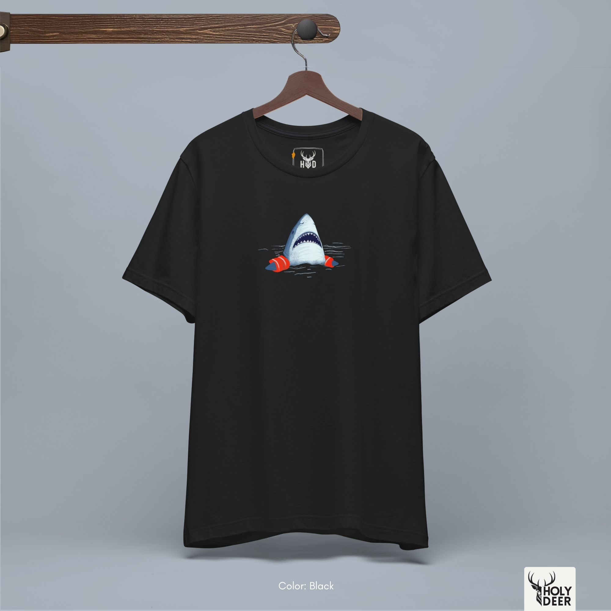 A detailed macro inspection of the Holydeer Clothing Gas Mask Graphic Tee focusing entirely on the vibrant Shark Floaties Tee accents. This specific section tracks the dense international orange ink coats, realistic inflation seam lines, and soft gray shadow drops wrapping around the sides of the shark lover gift creature.