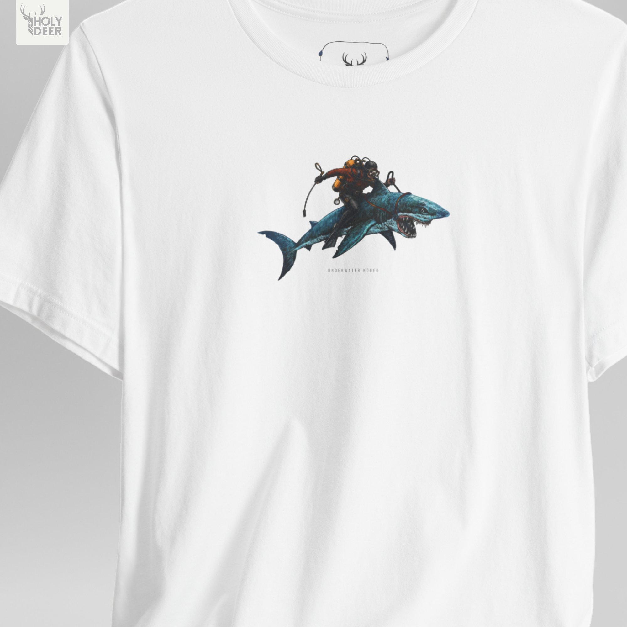 A detailed macro inspection of the Holydeer Clothing Shark Graphic Tee focusing entirely on the realistic predatory shark head print texture. This specific section tracks the deep teal skin gradients, open white pointed tooth lines, organic gill slits, and dense ink layering forming the core of the shark lover apparel symbol.