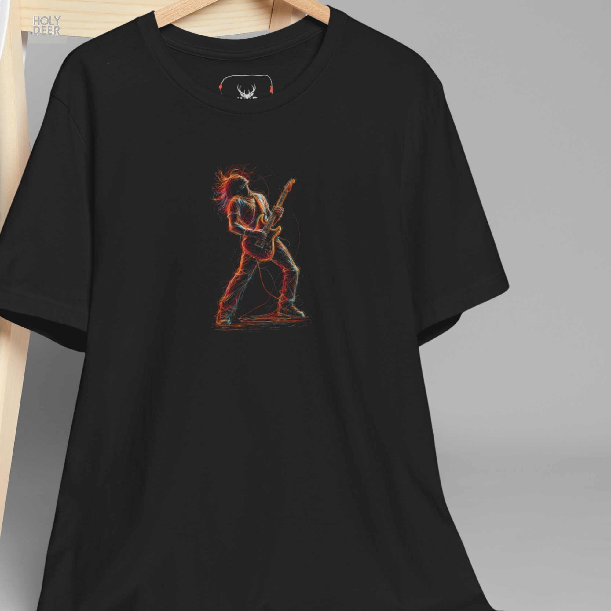 A detailed macro inspection of the Holydeer Clothing Guitarist Graphic T focusing entirely on the dynamic motion lines of the rock musician. This specific section tracks the scattered crimson hair locks, overlapping sketchy shoulder bounds, leaning torso angles, and glowing neon paint streaks forming the core of the hard rock clothing symbol.