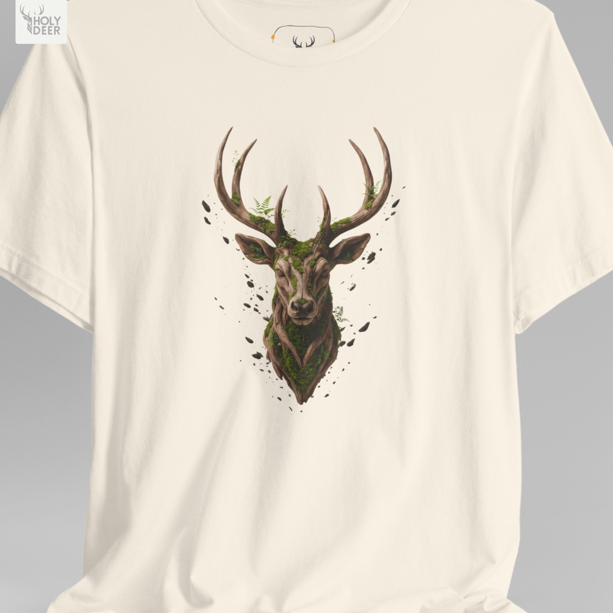 A technical macro view of the Holydeer Tee Deer Graphic Tee capturing the tiny floating leaf particles and desaturated forest dust graphics surrounding the central head. The frame monitors the clean graphic structure to secure high earthy concept wear layout cohesion, creating a premium presentation for our signature save the planet line.