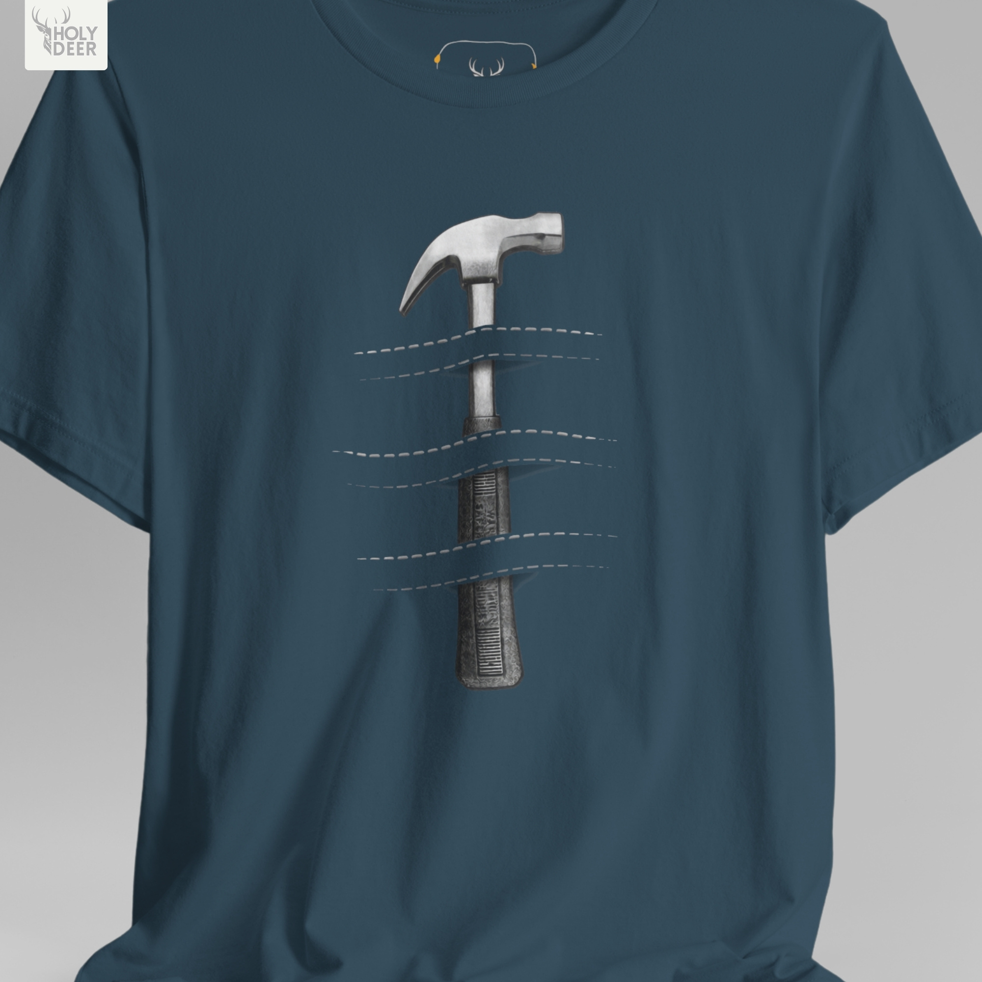 A technical macro view of the Holydeer Tee Hammer Graphic Tee capturing the cross-hatched rubber grid on the heavy grip handle. The frame monitors the clean graphic structure to secure high hardware tshirt layout cohesion, creating a premium presentation for our signature maker lifestyle t line.