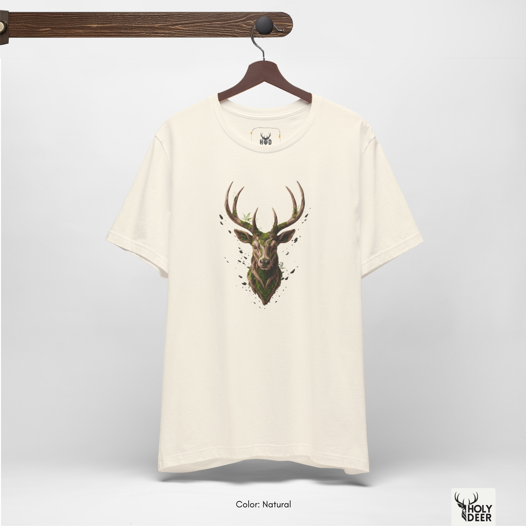 A commercial catalog layout tracking the Holydeer Clothing Deer Graphic Tee hanging cleanly from a custom timber stand. The product framework documents accurate mystic forest shirt material behavior, soft chest wrinkles, and balanced square casual fit parameters for high-end boutique distribution.