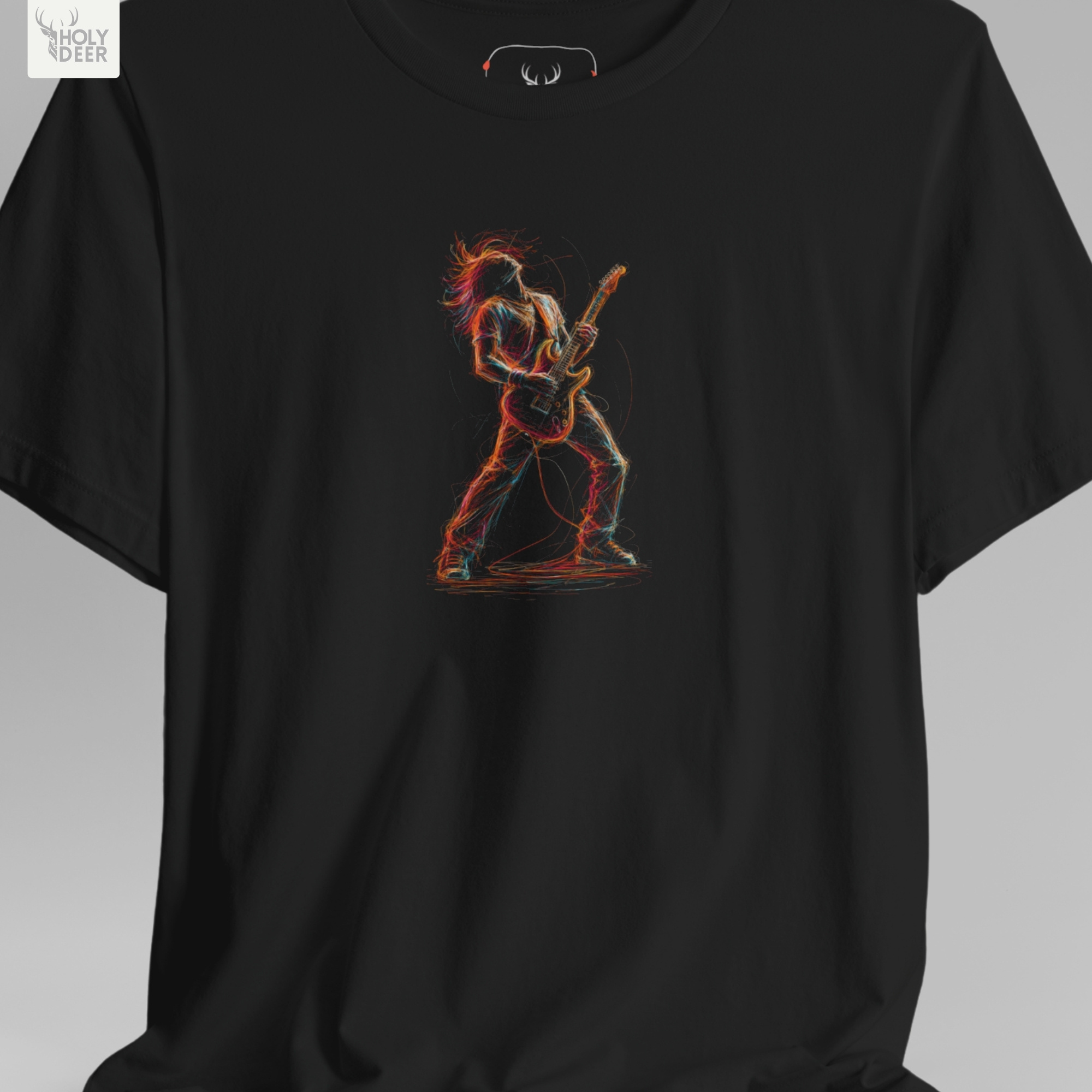 A technical macro view of the Holydeer Tee Guitarist Graphic T capturing the angular neon shadow trails and scattered energetic speed blocks beneath the musician. The frame monitors the clean graphic structure and overlapping color splashes to secure high concert graphic tee layout cohesion, creating a premium presentation for our signature line.