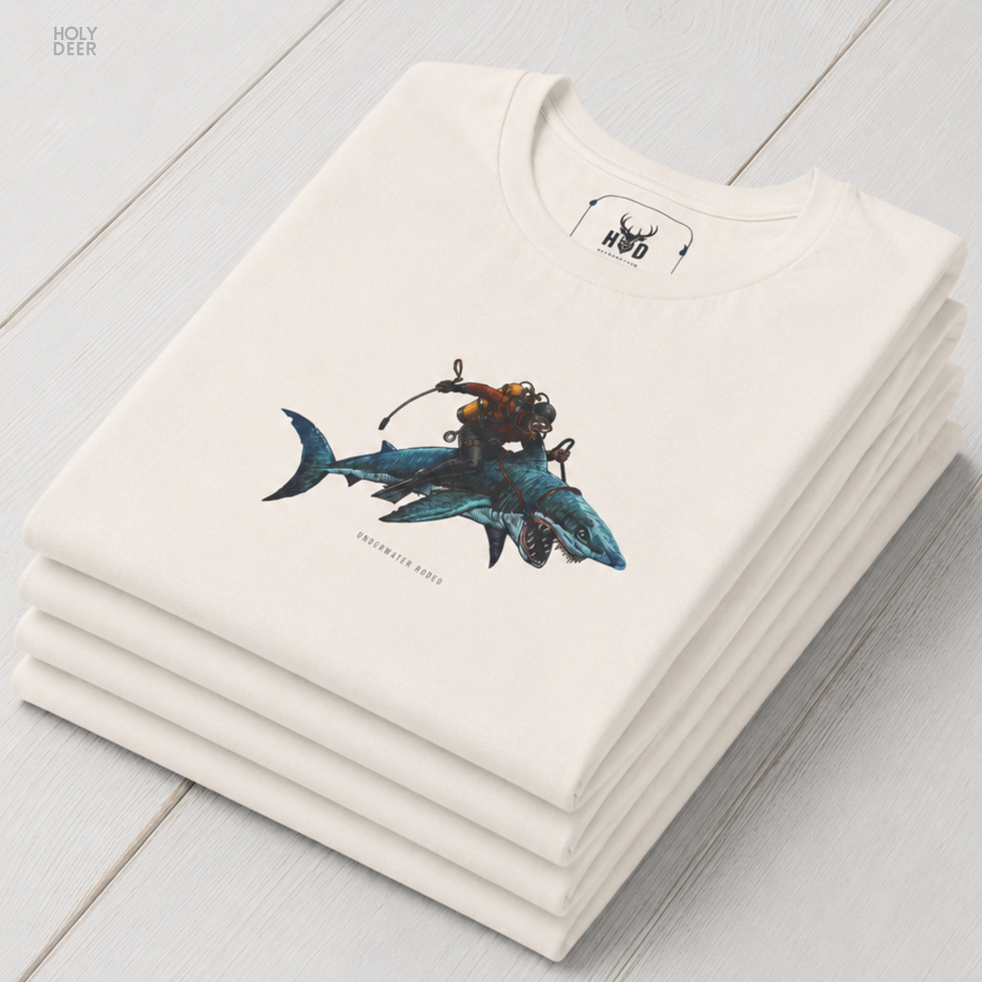 A commercial catalog layout tracking the Holydeer Clothing Shark Graphic Tee hanging cleanly from a custom timber stand. The product framework documents accurate diver gift shirt material behavior, soft chest wrinkles, and balanced square casual fit parameters for high-end boutique distribution.