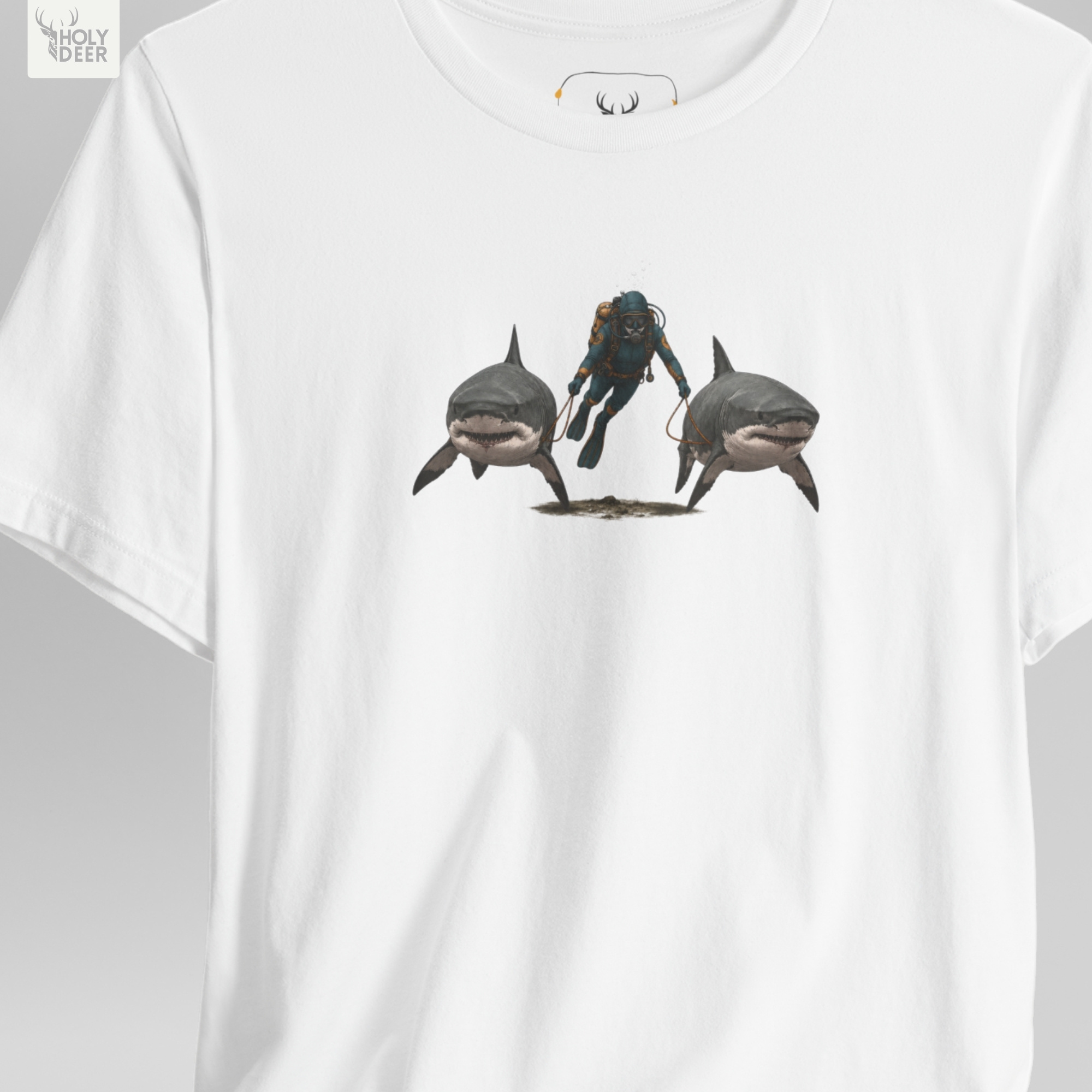 A full-length street fashion lookbook photo displaying a creator styling the Holydeer Apparel Shark Graphic Tee. The model pairs the independent boutique streetwear and funny scuba tee with loose casual gray utility trousers and deep design style accessories inside a raw minimalist brutalist concrete architectural hall.
