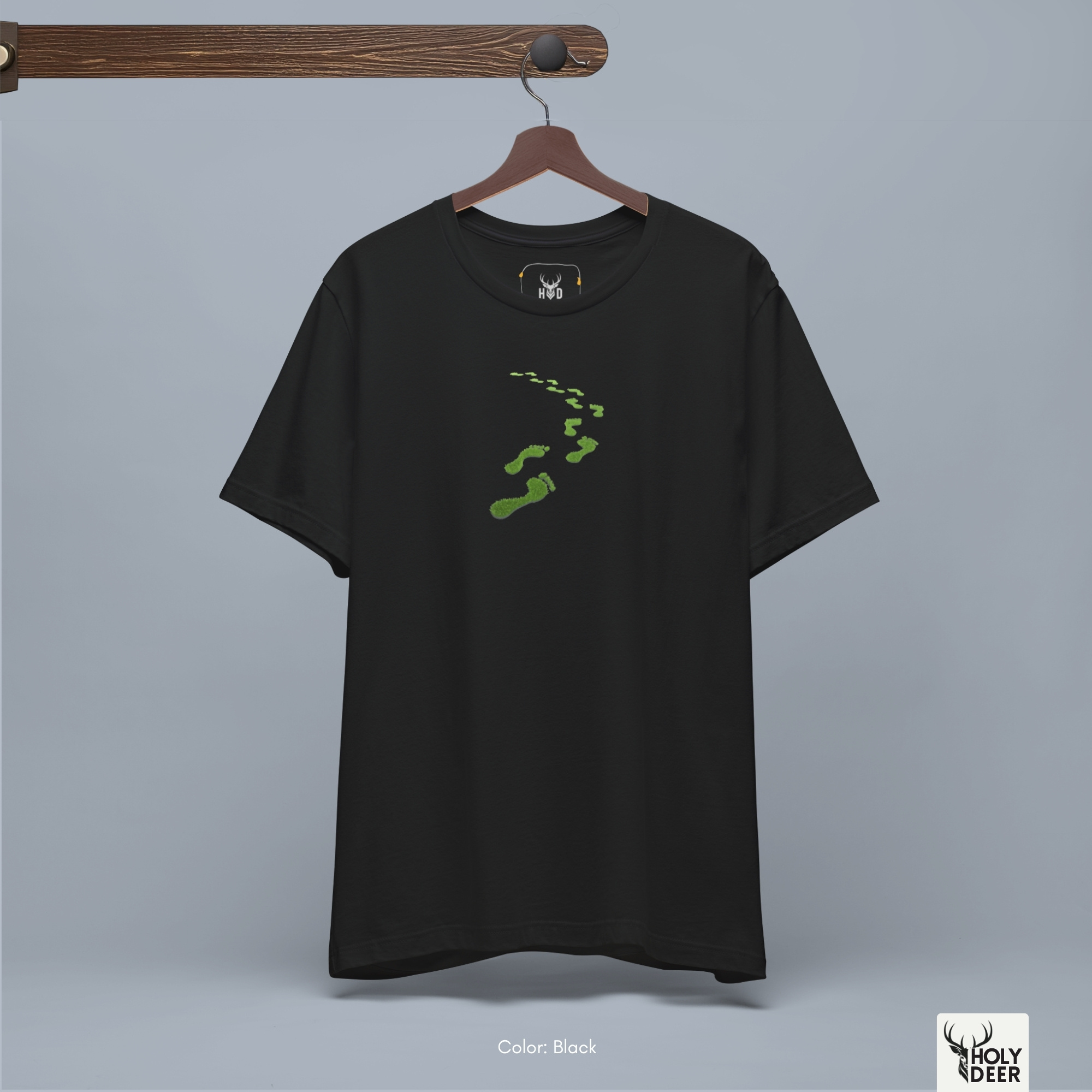 A commercial catalog layout tracking the Holydeer Clothing Green Steps Shirt hanging cleanly from a custom timber stand. The product framework documents accurate nature walk apparel material behavior, soft chest wrinkles, and balanced square casual fit parameters for high-end boutique distribution.