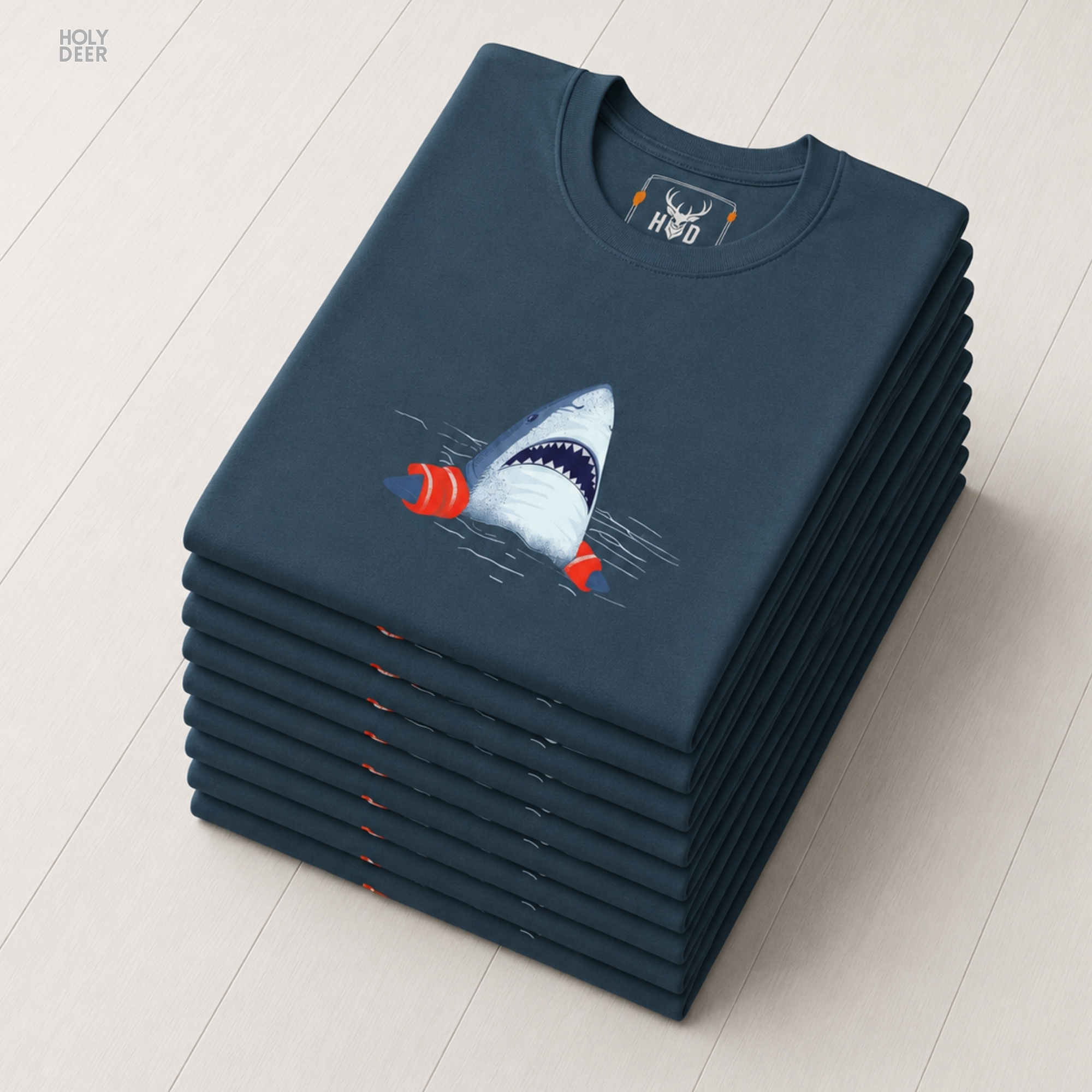 A close showroom catalog viewpoint of the Holydeer Apparel Shark Graphic Tee showing the specialized Humorous Shark T printing finish. The framework tracks the tight screen registration of this Cute Sea Life Top and Beach Humor Shirt selection to monitor print density, material texturing behaviors, and light reflection.