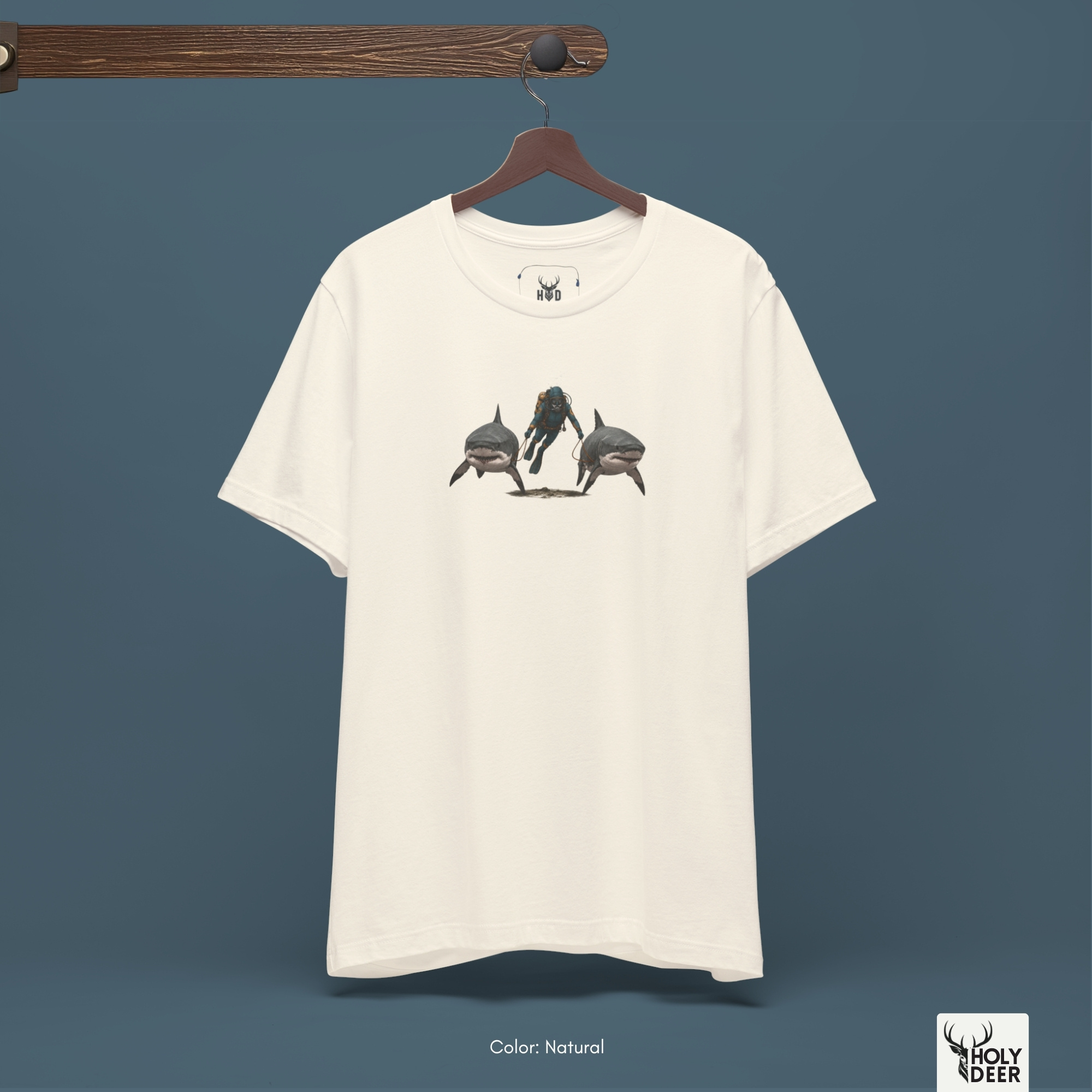 A commercial catalog layout tracking the Holydeer Clothing Shark Graphic Tee hanging cleanly from a custom timber stand. The product framework documents accurate funny scuba tee material behavior, soft chest wrinkles, and balanced square casual fit parameters for high-end boutique distribution.