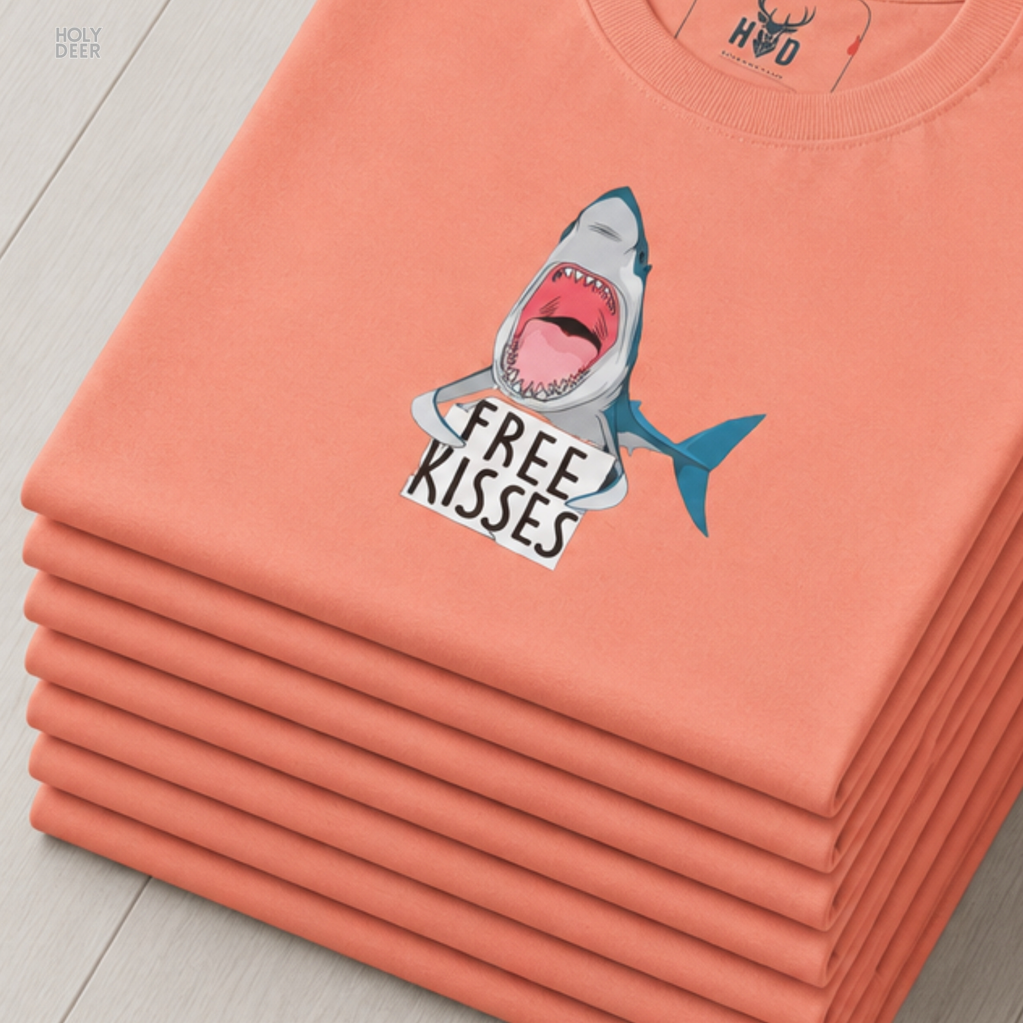 A close showroom catalog viewpoint of the Holydeer Apparel Shark Graphic Tee showing the specialized Beach Lifestyle Wear printing finish. The framework tracks the tight screen registration of this Funny Shark Shirt and Shark Lover Gift selection to monitor deep design style rendering, material texturing behaviors, and light reflection.