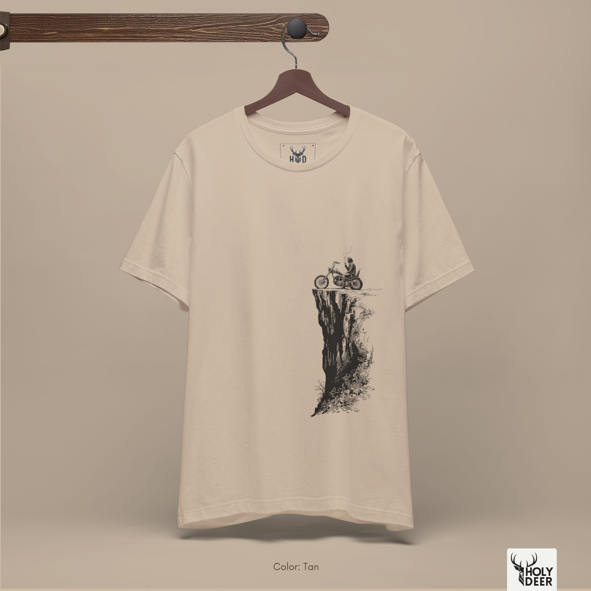 A commercial catalog layout tracking the Holydeer Clothing Biker Graphic Tee hanging cleanly from a custom timber stand. The product framework documents accurate motorbike shirt material behavior, soft chest wrinkles, and balanced square casual fit parameters for high-end boutique distribution.