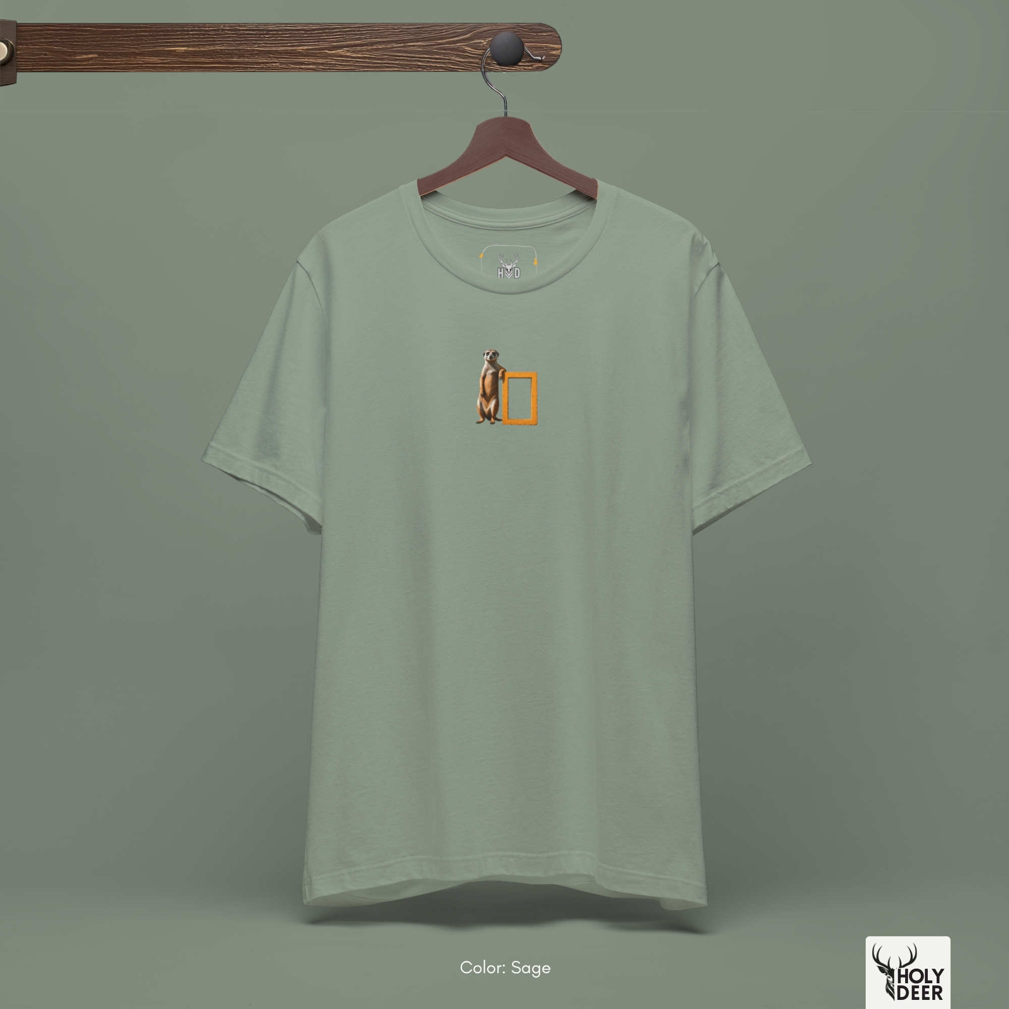 An abstract moody editorial lookbook grid manipulating deep fabric wrinkles and harsh side spotlight shadows on the Holydeer Streetwear Meerkat Graphic Tee. This high-contrast minimalist meerkat and cute meerkat top treatment demonstrates how the central yellow and tan geographic parody print maintains striking visual pop.